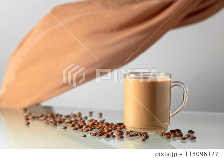 Coffee with cream on a glass table. 113096127