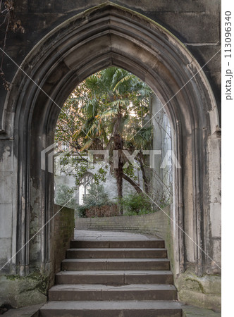 The stone arched entrance leads to the stone staircase inside of St Dunstan in the East Church Garden. 113096340