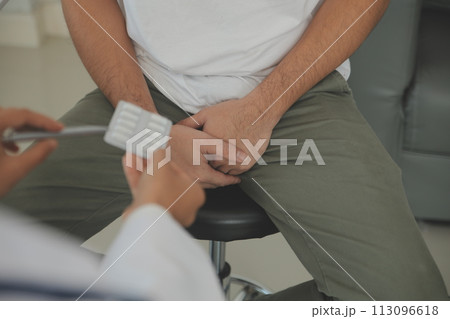 Male diseases. Man presses hands to his groin and suffering from pain, panorama, cropped, studio shot Male diseases. Man presses hands to his groin and suffering from pain, panorama, cropped, studio shot 113096618
