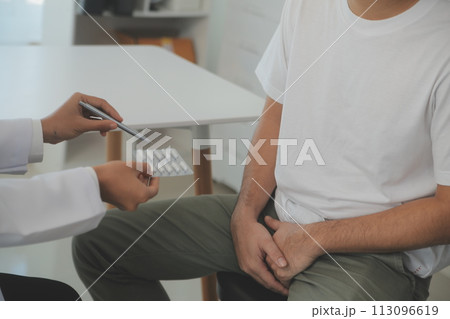 Male diseases. Man presses hands to his groin and suffering from pain, panorama, cropped, studio shot Male diseases. Man presses hands to his groin and suffering from pain, panorama, cropped, studio shot 113096619