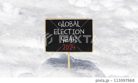 Global election year 2024 symbol. Concept words Global election year 2024 on beautiful black chalk blackboard. Beautiful white snow background. Business Global election year 2024 concept. Copy space Global election year 2024 symbol. Concept words Global election year 2024 on beautiful black chalk blackboard. Beautiful white snow background. Business Global election year 2024 concept. Copy space 113097668