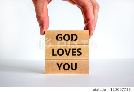 God loves you symbol. Concept words 'God loves you' on wooden blocks on a beautiful white background, prayer hand. Copy space. Religion and God loves you concept. 113097738