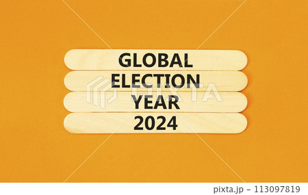 Global election year 2024 symbol. Concept words Global election year 2024 on wooden stick. Beautiful orange table orange background. Business Global election year 2024 concept. Copy space. Global election year 2024 symbol. Concept words Global election year 2024 on wooden stick. Beautiful orange table orange background. Business Global election year 2024 concept. Copy space. 113097819
