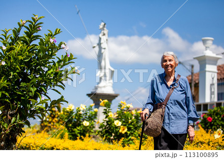Senior woman tourist at the beautiful heritage town of Salamina in the department of Caldas in Colombia 113100895