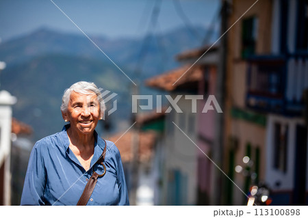 Senior woman tourist at the beautiful heritage town of Salamina in the department of Caldas in Colombia 113100898