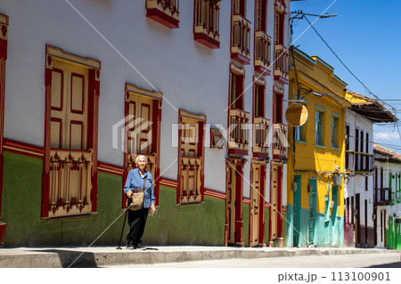 Senior woman tourist at the beautiful heritage town of Salamina in the department of Caldas in Colombia 113100901