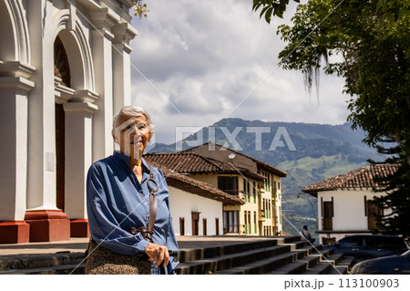 Senior woman tourist at the beautiful heritage town of Salamina in the department of Caldas in Colombia 113100903