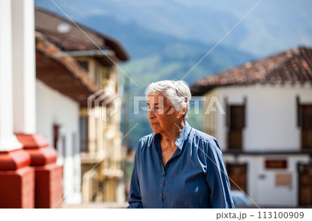 Senior woman tourist at the beautiful heritage town of Salamina in the department of Caldas in Colombia 113100909