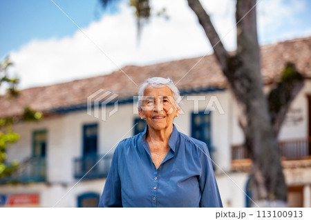 Senior woman tourist at the beautiful heritage town of Salamina in the department of Caldas in Colombia 113100913