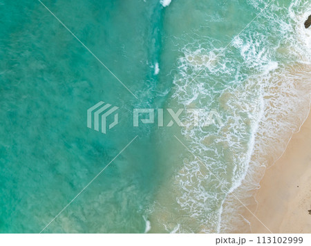 Top view beach with waves crashing on sandy shore,Beautiful waves sea surface in summer seascape background,Amazing beach colorful water background 113102999