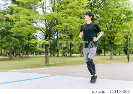 公園でランニング・ジョギング・トレーニング・有酸素運動をする若い男性 公園でランニング・ジョギング・トレーニング・有酸素運動をする若い男性 113104269