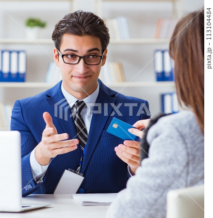 Woman makes payment with credit card 113104484