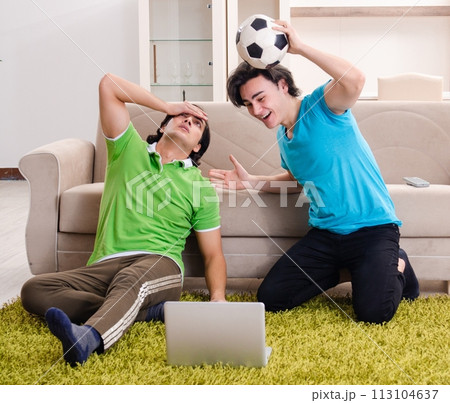 Friends watching football at home Friends watching football at home 113104637