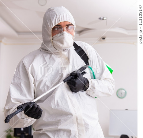 Contractor disinfecting office for COVID-19 coronavirus 113105147