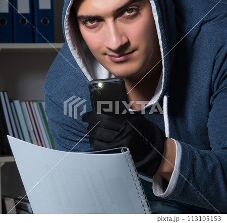 Young man in industrial espionage concept 113105153