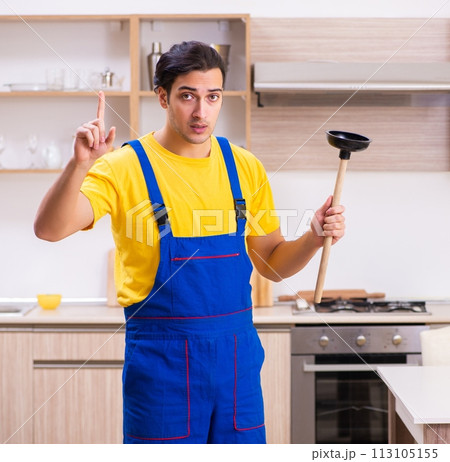 Young male contractor repairing tap at home 113105155