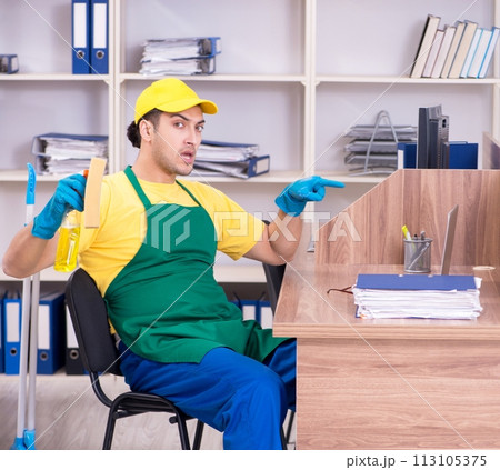 Young male contractor cleaning the office 113105375