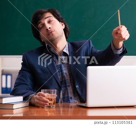 Male teacher drinking in the classroom 113105381