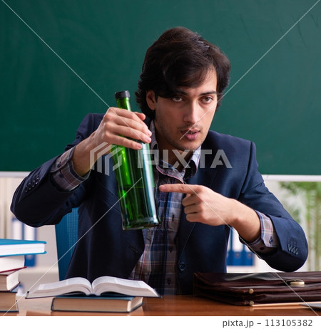 Male teacher drinking in the classroom Male teacher drinking in the classroom 113105382