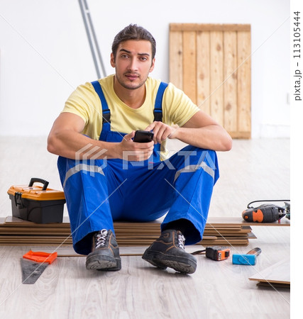 Young male contractor working indoors 113105444
