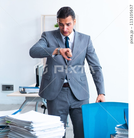 Businessman with heavy paperwork workload Businessman with heavy paperwork workload 113105637