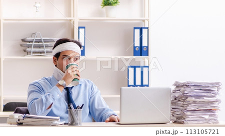 Young injured male employee working in the office Young injured male employee working in the office 113105721