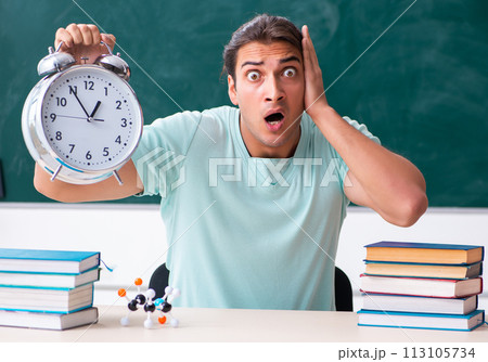 Young male student sitting in the classroom Young male student sitting in the classroom 113105734