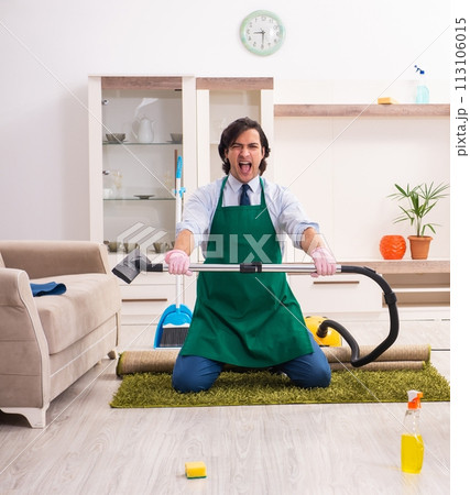 Young businessman cleaning the house Young businessman cleaning the house 113106015