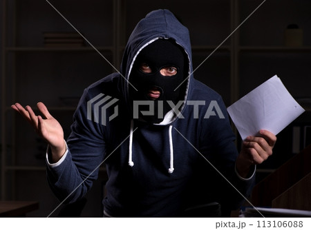 Male thief in balaclava in the office night time 113106088