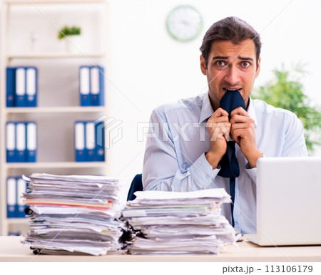 Young male employee unhappy with excessive work Young male employee unhappy with excessive work 113106179