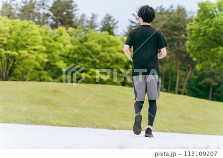 公園でウォーキング・ジョギング・ランニング・運動・有酸素運動・トレーニングをする若い男性 公園でウォーキング・ジョギング・ランニング・運動・有酸素運動・トレーニングをする若い男性 113109207
