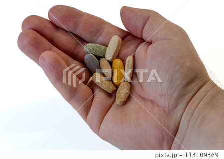 A portion of a dietary supplement of vitamins in hand A portion of a dietary supplement of vitamins in hand 113109369