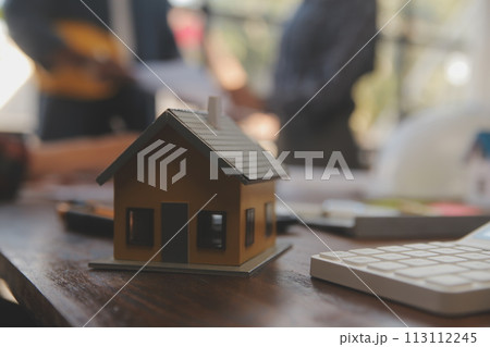 A team of construction engineers talks to managers and construction workers at the construction site. Quality inspection, work plan, home and industrial building design project 113112245