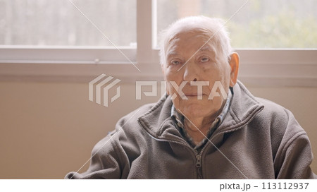 Aged man looking serious sitting on a geriatric Aged man looking serious sitting on a geriatric 113112937