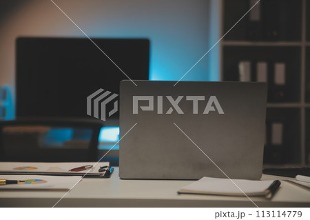 Laptop and paperwork on conference table Laptop and paperwork on conference table 113114779