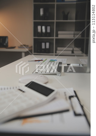 Laptop and paperwork on conference table Laptop and paperwork on conference table 113114802