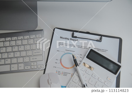 Laptop and paperwork on conference table 113114823