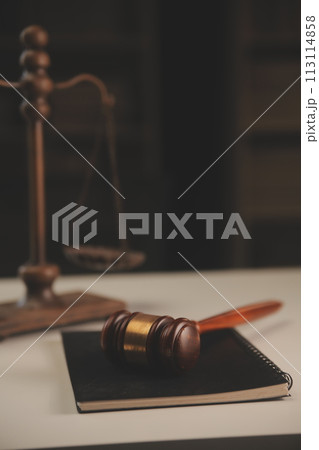 image of judge's hammer, scales lady of justice, law book, laptop computer and contract documents with pen concept of law and justice. image of judge's hammer, scales lady of justice, law book, laptop computer and contract documents with pen concept of law and justice. 113114858