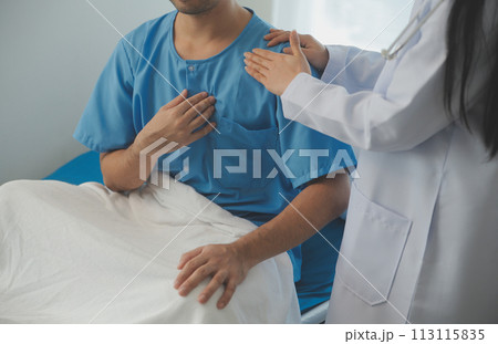 Young doctor is using a stethoscope listen to the heartbeat of the patient. Shot of a female doctor giving a male patient a check up 113115835