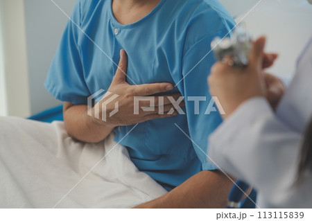 Young doctor is using a stethoscope listen to the heartbeat of the patient. Shot of a female doctor giving a male patient a check up 113115839