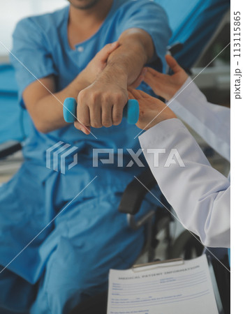 Physiotherapist man giving exercise with dumbbell treatment About Arm and Shoulder of athlete male patient Physical therapy concept 113115865