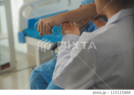 Physiotherapist man giving exercise with dumbbell treatment About Arm and Shoulder of athlete male patient Physical therapy concept 113115866
