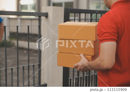 Asian delivery express courier young man use giving boxes to woman customer he wearing protective face mask at front home 113115909