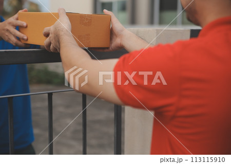 Asian delivery express courier young man use giving boxes to woman customer he wearing protective face mask at front home 113115910