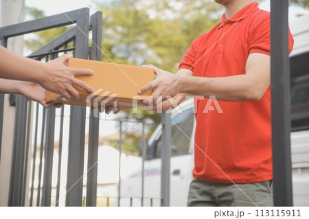 Asian delivery express courier young man use giving boxes to woman customer he wearing protective face mask at front home 113115911