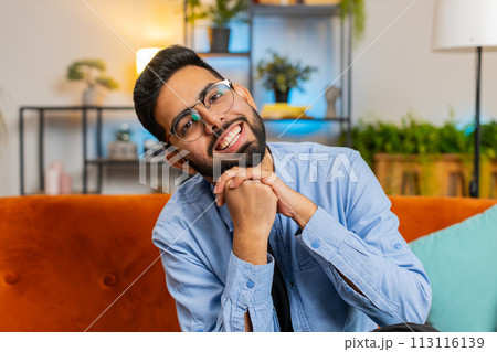 Indian man laughing out loud after hearing ridiculous anecdote funny positive joke at home room 113116139