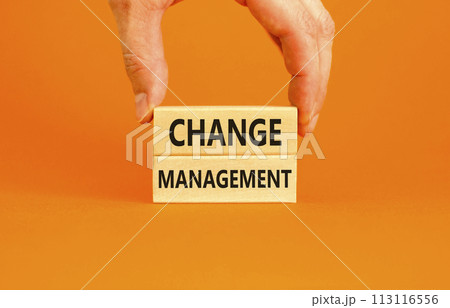 Change management symbol. Concept words Change management on beautiful wooden block. Beautiful orange table orange background. Businessman hand. Business change management concept. Copy space. Change management symbol. Concept words Change management on beautiful wooden block. Beautiful orange table orange background. Businessman hand. Business change management concept. Copy space. 113116556