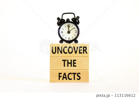 Uncover the facts symbol. Concept words Uncover the facts on wooden blocks on a beautiful white table white background. Black alarm clock. Business and uncover the facts concept. Copy space. Uncover the facts symbol. Concept words Uncover the facts on wooden blocks on a beautiful white table white background. Black alarm clock. Business and uncover the facts concept. Copy space. 113116612