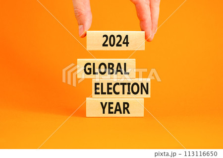 2024 global election year symbol. Concept words 2024 global election year on beautiful block. Beautiful orange table background. Voter hand. Business 2024 global election year concept. Copy space 2024 global election year symbol. Concept words 2024 global election year on beautiful block. Beautiful orange table background. Voter hand. Business 2024 global election year concept. Copy space 113116650
