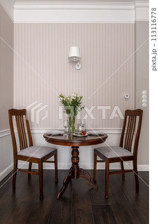 Corner of the room furnished with table and chairs Corner of the room furnished with table and chairs 113116778